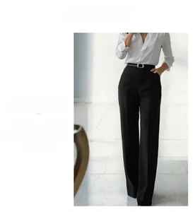 Detail view of high waist wide leg black trousers with front crease showing draped fabric