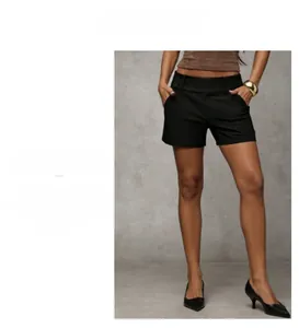 Detail of high-waisted black wide-leg shorts featuring a side buckle and structured fabric
