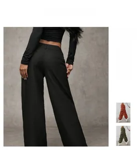 Detail of high-waisted wide-leg trousers in black, rust red and army green fabrics