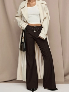 Women's high waist flared pants in deep brown with a belt, styled with a beige trench coat