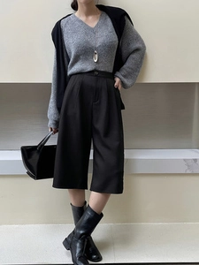 Women's high waist wide leg culottes with gray V-neck sweater and leather boots