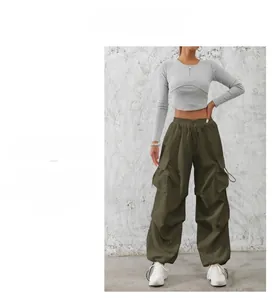 Detail showing elastic high waistband with drawstring on olive green cargo pants