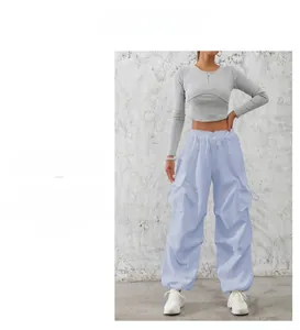 Detail of high-waist cargo pants with large side pockets and drawstring waist design