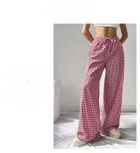 Detail of high-waisted red and white plaid wide-leg pants with drawstring waist