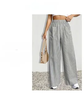 Close-up of high-waisted wide-leg striped trousers with elastic waistband and large pockets