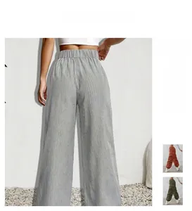 Detail of high-waisted wide-leg trousers with elastic back waistband and striped pattern