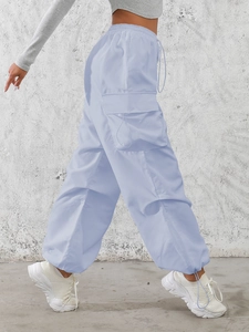 High-waisted light blue cargo pants with large side pockets and drawstring hem design