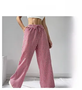 Detail of high waisted gingham wide leg trousers featuring an adjustable drawstring waist