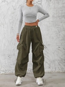 Women street style outfit with grey cropped hoodie and olive green cargo pants with pockets