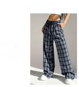 Detail of high-waisted navy plaid wide-leg trousers with adjustable drawstring waist