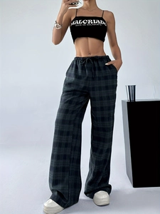 Detail view of high waist plaid wide leg trousers with adjustable drawstring waist and relaxed fit