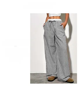 Close-up of black and white checkered wide-leg trousers with elastic drawstring waist