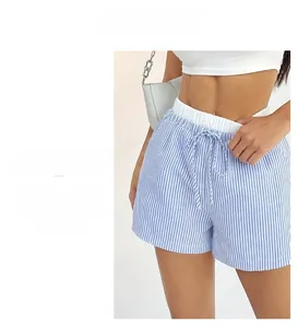 Detail view of blue and white vertical striped wide-leg shorts with drawstring waist