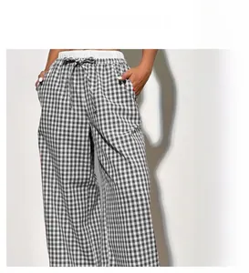Close-up of black and white checkered wide leg pants with white drawstring waist detail
