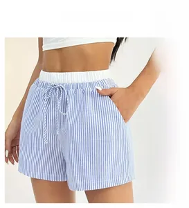 Detail of high-waisted blue and white striped shorts with elastic drawstring waistband