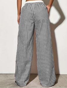 Close-up of black and white gingham wide-leg pants with elastic drawstring waistband