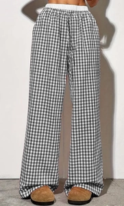 Detail of black and white gingham wide-leg trousers with elastic drawstring waistband