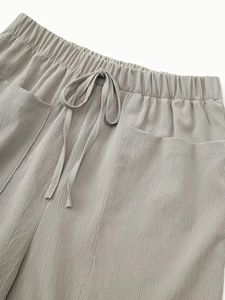 Relaxed fit light gray wide-leg shorts with elastic drawstring waist and patch pockets