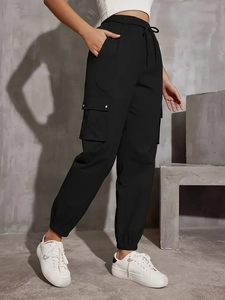 Women's black high-waist cargo jogger pants with side flap pockets and drawstring waist