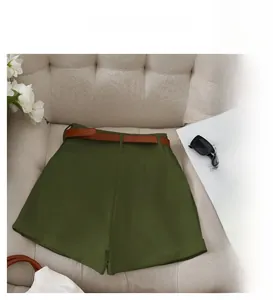 Army green high-waisted shorts with a slim brown belt in a high-quality lifestyle shot