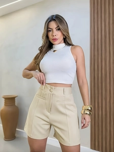 Women's summer outfit with white sleeveless crop top and beige high-waisted wide-leg shorts