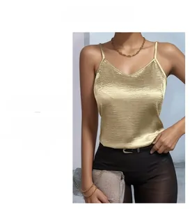 Detailed view of champagne satin camisole with thin straps and elegant v-neckline