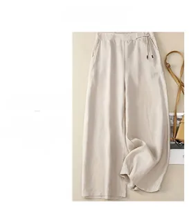 Detail of high waisted cotton linen wide leg trousers with drawstring waist and side pockets