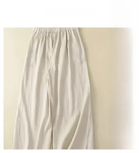 Detail view of high waisted linen wide leg trousers with elastic waist and side pockets