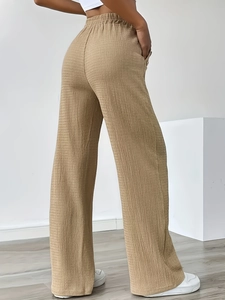 Khaki high waisted wide leg trousers with pleated texture and elastic waistband