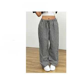 Detail of high waist black and white checkerboard wide leg pants with drawstring cord