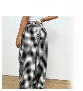 Detail of the elastic waistband and back fit on black and white plaid wide-leg pants