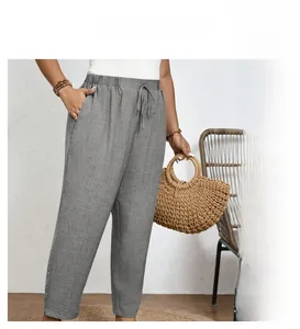 Detailed view of grey linen drawstring waist pants featuring practical side pockets