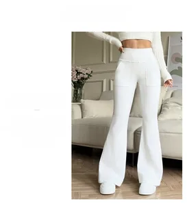 Detail showing high-waisted flared trousers with functional side pockets in white knit fabric