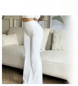 Detailed close-up showing high waist design and slimming fit of white flare pants
