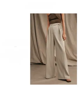 Detail of high waisted wide leg trousers with waist tie and pleated front design