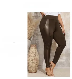 Detail of high waist leggings with matte fabric and glossy faux leather stitching