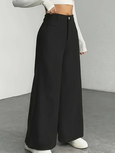 High-waisted black wide-leg trousers with vertical ribbed texture and minimalist style