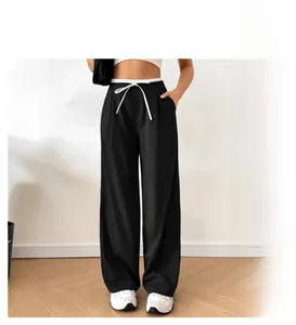 Detail showing the white drawstring waist and double-layer lining of these straight trousers