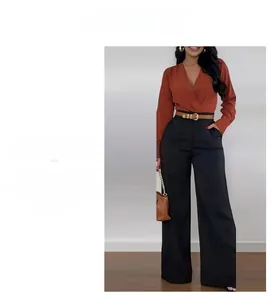Detail view of high-waist wide-leg trousers with a brown leather belt and V-neck top