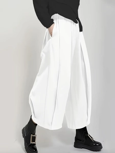 White high-waist wide leg pleated trousers for women with fluid drape and minimalist style