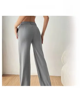 Detail of high-waisted wide leg trousers in grey, brown and green drape fabric
