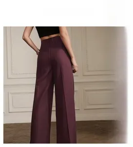Detail of high-waist purple wide-leg pants showing elastic waistband and crepe fabric texture