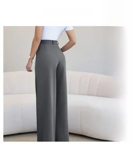 Detail of high-waist straight-leg trousers with elastic waistband and draped fabric texture