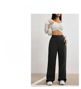 Detail of high-waisted black wide-leg trousers with elegant drape for a slim minimalist look