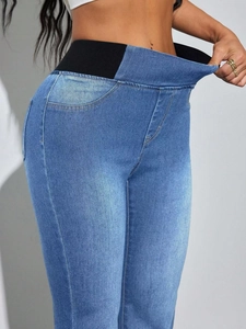 High waist light blue denim jeggings with black elastic waistband showing high stretch and comfort