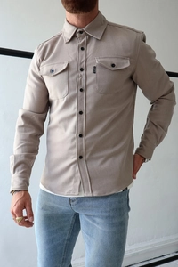 Detail of oat grey brushed flannel shirt featuring chest pockets and branded labels