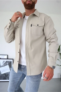 Detail of light khaki brushed twill shirt with flap chest pockets and small CAPO brand label