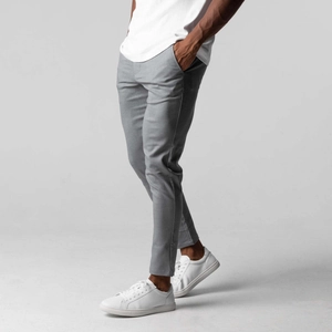 Detail shot of slim fit mid-grey men's casual trousers with premium fabric texture