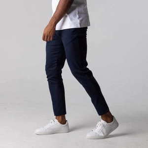 Slim fit navy casual cotton trousers for men paired with white sneakers and t-shirt