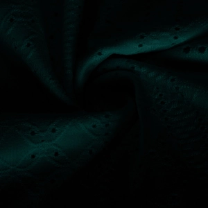 Macro shot of dark green hollow-out eyelet fabric with wave embroidery detail
